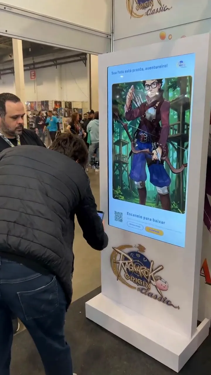Visitante escaneia o QR Code no totem enquanto seu personagem de Ragnarok aparece na tela
